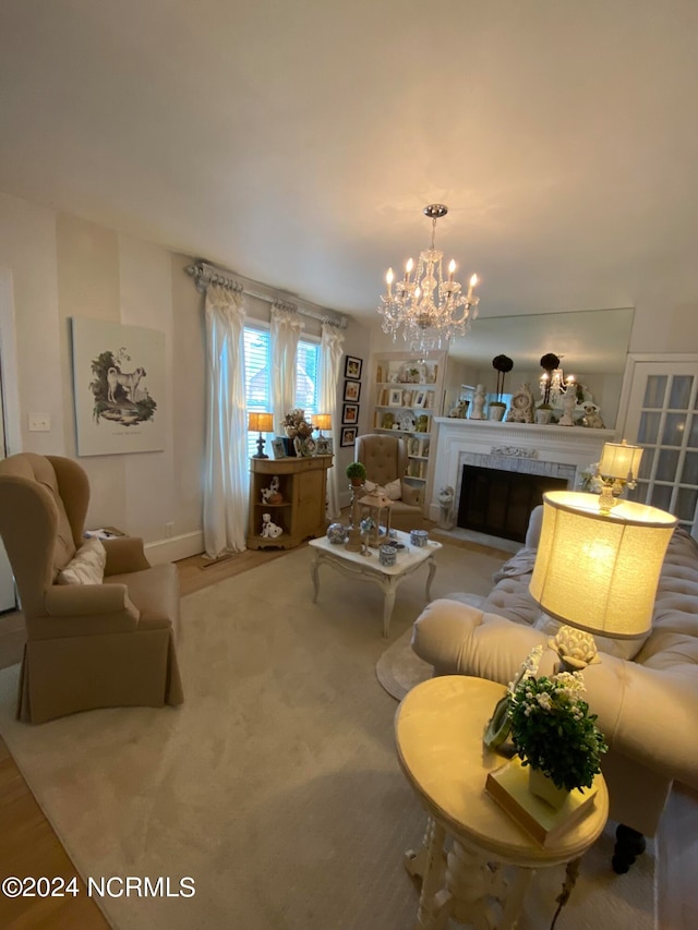 carpeted living room with an inviting chandelier