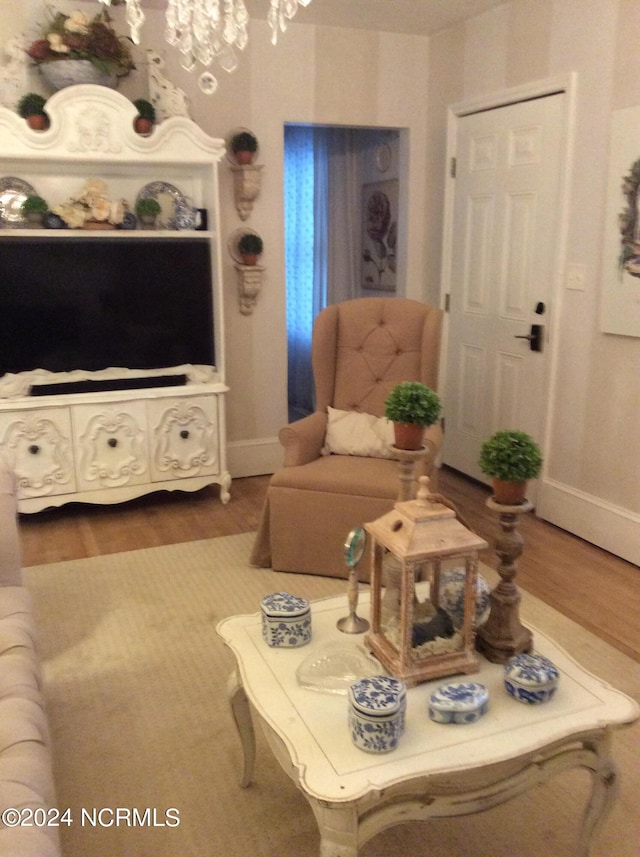 living room with wood-type flooring and a chandelier