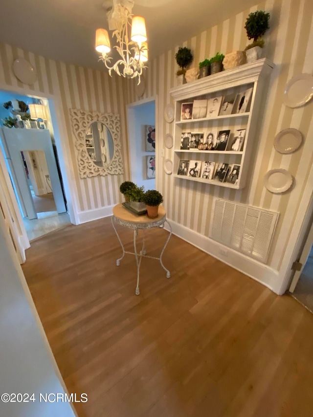 dining room with wood-type flooring and a chandelier