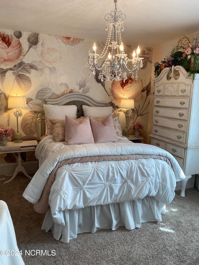 bedroom featuring a textured ceiling, carpet, and an inviting chandelier