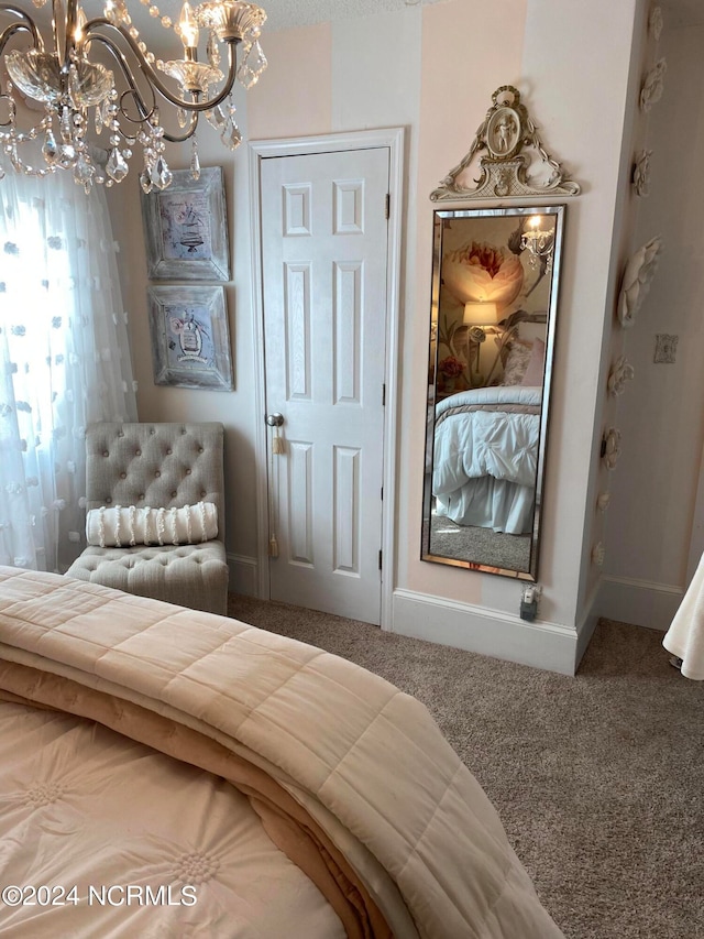 bedroom with carpet floors and an inviting chandelier