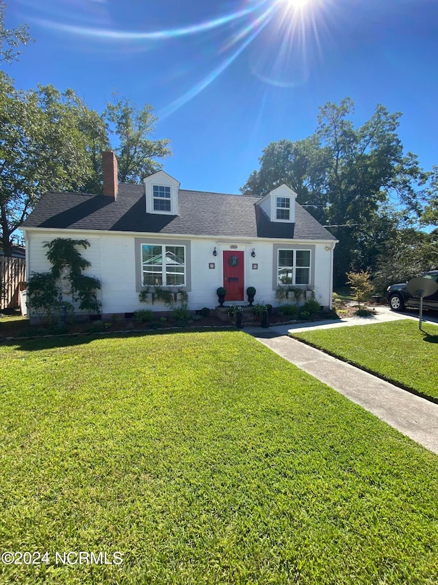 new england style home featuring a front yard