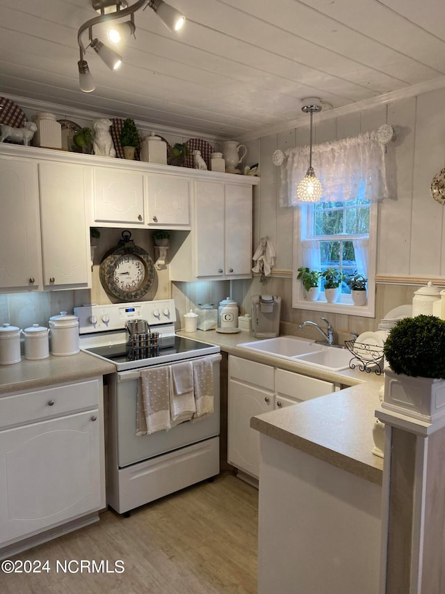 kitchen featuring pendant lighting, light wood-type flooring, electric range, sink, and white cabinets