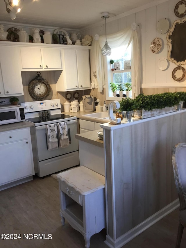 kitchen with dark hardwood / wood-style floors, white cabinetry, hanging light fixtures, white appliances, and crown molding