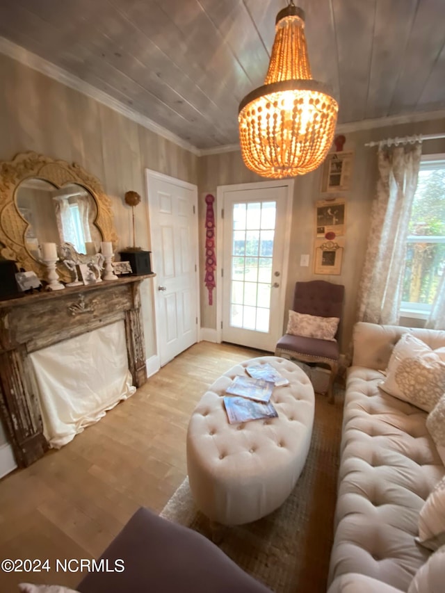 living room featuring a notable chandelier, ornamental molding, hardwood / wood-style floors, and wood ceiling