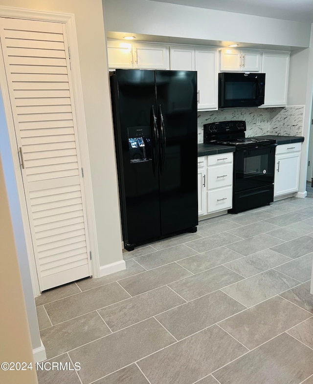 kitchen with white cabinets, backsplash, and black appliances