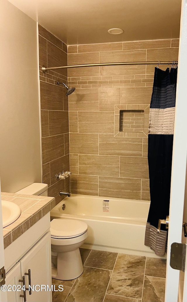 full bathroom with shower / bath combination with curtain, toilet, and vanity