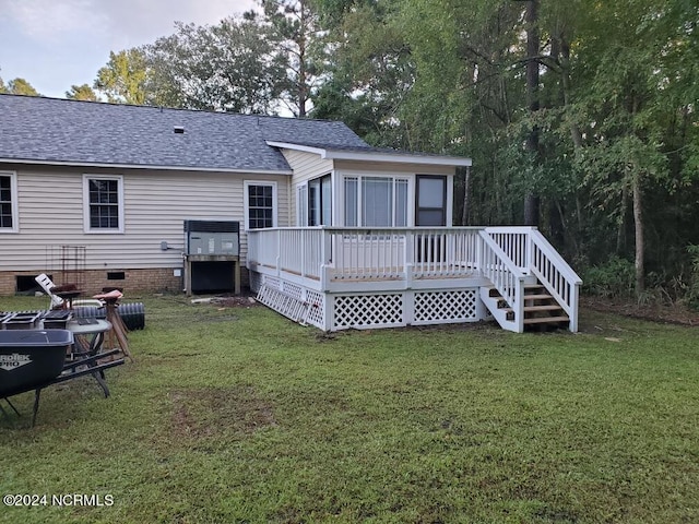 back of property featuring a yard and a deck