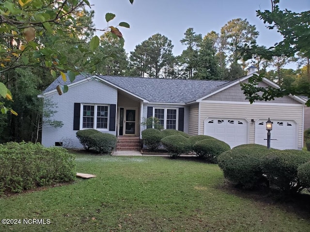 single story home featuring a front yard and a garage