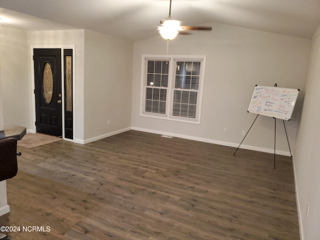 empty room featuring dark hardwood / wood-style floors, vaulted ceiling, and ceiling fan