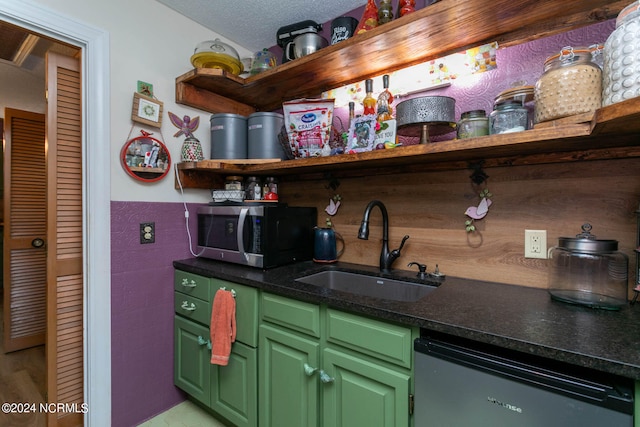 kitchen featuring a textured ceiling, sink, green cabinets, and stainless steel appliances