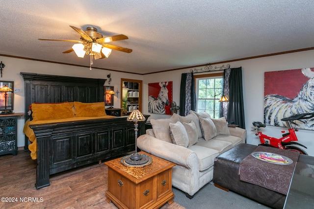 bedroom featuring a textured ceiling, crown molding, ceiling fan, and hardwood / wood-style flooring