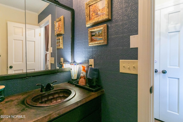 bathroom featuring ornamental molding and vanity