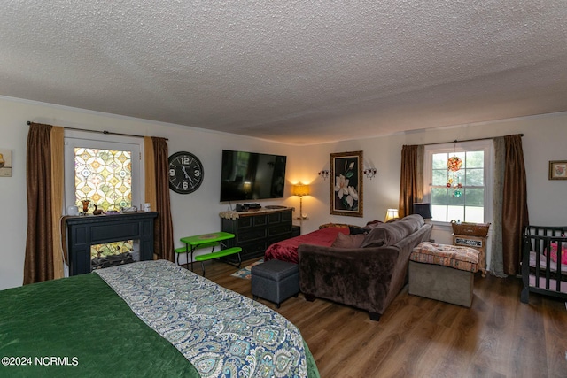 bedroom with a textured ceiling and hardwood / wood-style flooring