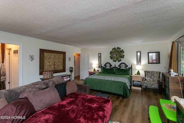 bedroom featuring a textured ceiling and dark hardwood / wood-style flooring