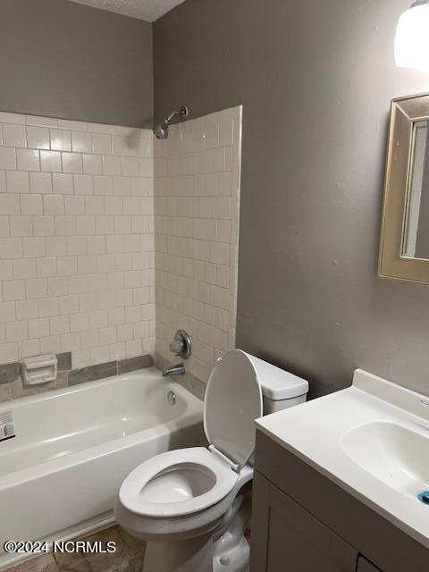 full bathroom with vanity, toilet, and tiled shower / bath