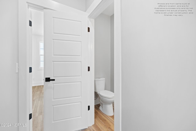 bathroom featuring toilet and hardwood / wood-style flooring