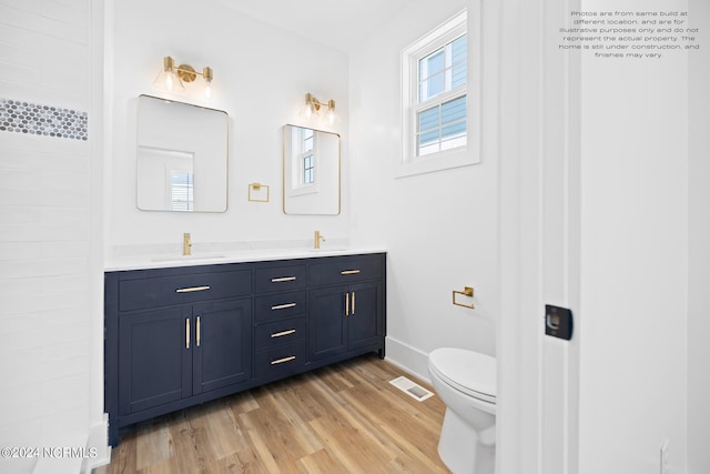 bathroom with vanity, hardwood / wood-style flooring, and toilet