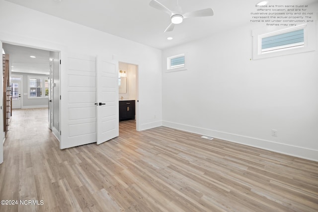 unfurnished bedroom featuring light hardwood / wood-style floors, connected bathroom, and ceiling fan