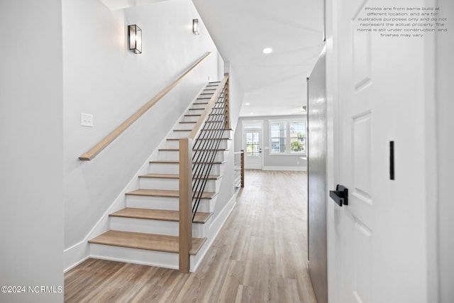 staircase with hardwood / wood-style floors