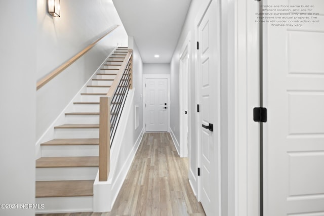 stairway with hardwood / wood-style flooring