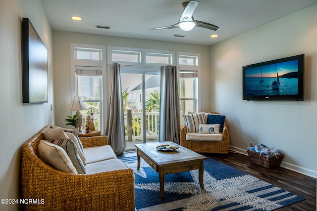 living room with dark hardwood / wood-style floors and ceiling fan