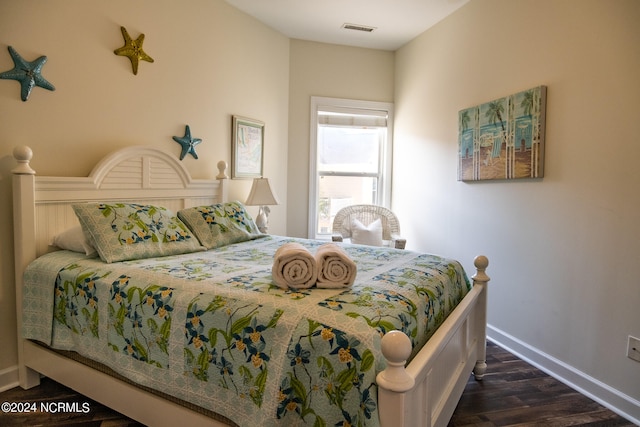 bedroom featuring dark hardwood / wood-style flooring