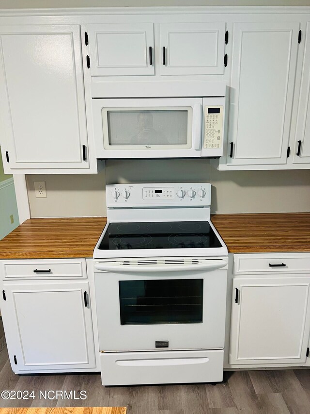 kitchen with white cabinets, white appliances, and dark wood-type flooring