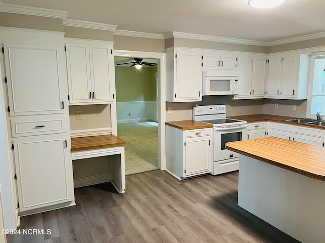 kitchen with white cabinets, sink, ornamental molding, white appliances, and hardwood / wood-style floors