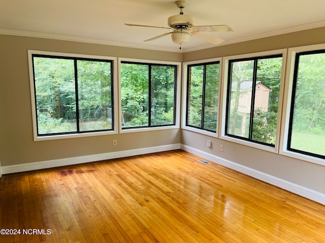 unfurnished sunroom with ceiling fan and plenty of natural light