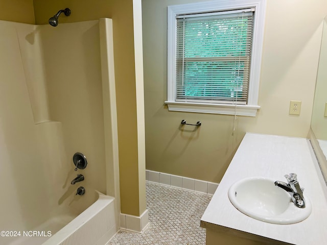 bathroom with tile patterned flooring, shower / bath combination, and vanity