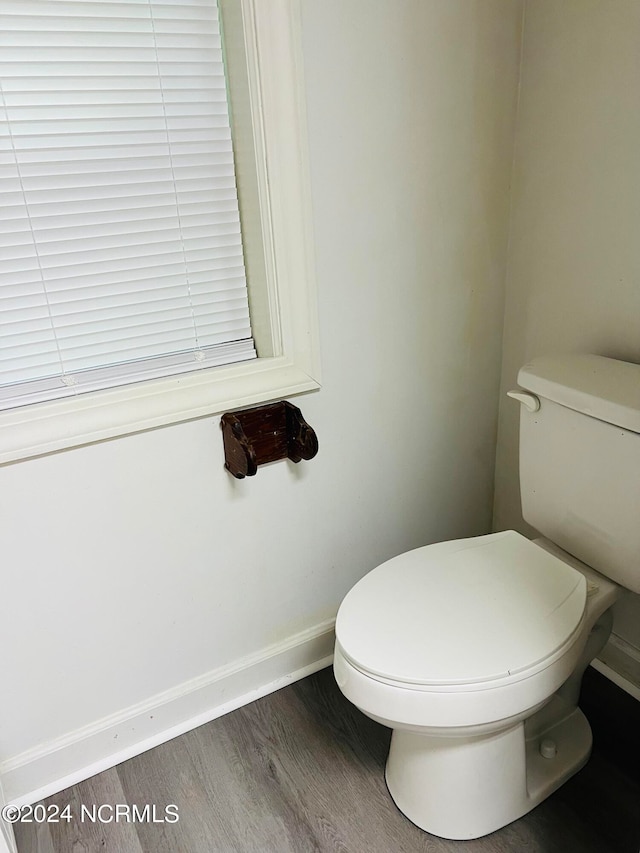 bathroom featuring hardwood / wood-style floors and toilet