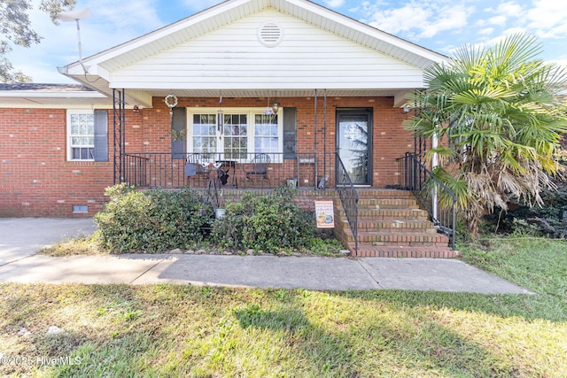 bungalow featuring crawl space, a porch, and brick siding