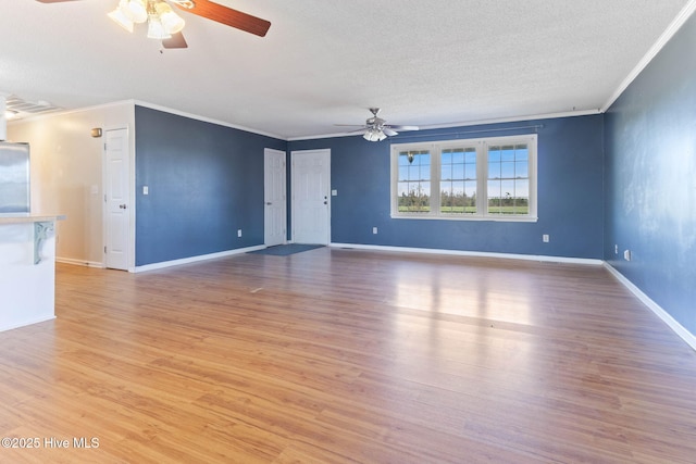 empty room featuring baseboards, ornamental molding, a textured ceiling, and light wood-style floors