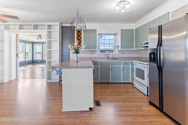 kitchen with white electric stove, visible vents, stainless steel fridge with ice dispenser, wood finished floors, and under cabinet range hood