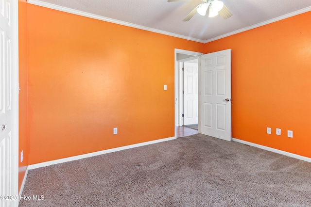 spare room with carpet flooring, crown molding, and baseboards