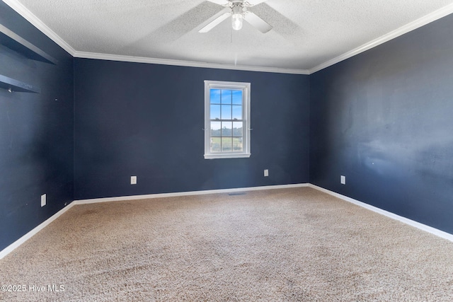 carpeted empty room featuring a ceiling fan, crown molding, a textured ceiling, and baseboards