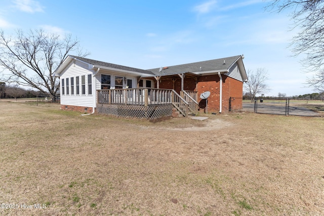 view of front facade featuring a deck, brick siding, fence, crawl space, and a front yard