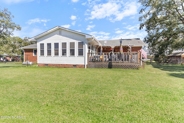 rear view of house with crawl space, a yard, fence, and a wooden deck