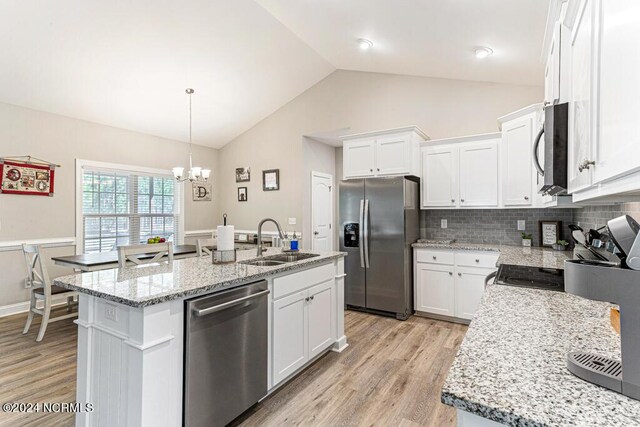 kitchen with light hardwood / wood-style flooring, an island with sink, stainless steel appliances, and white cabinetry