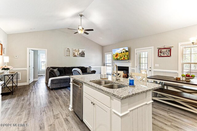 kitchen featuring white cabinets, hanging light fixtures, sink, a center island with sink, and stainless steel appliances