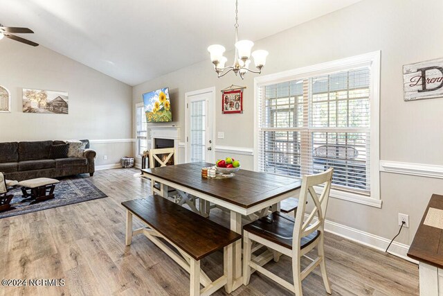 kitchen featuring ceiling fan, white cabinets, lofted ceiling, a center island with sink, and stainless steel appliances