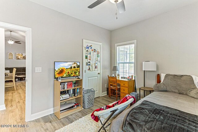 bedroom with ceiling fan, hardwood / wood-style flooring, and multiple windows