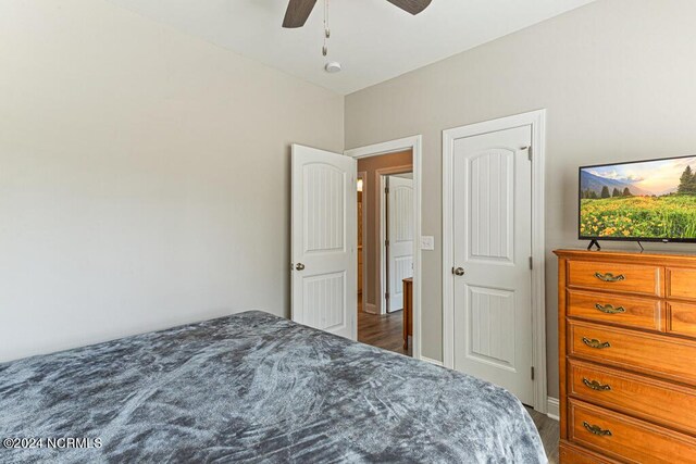 bedroom with ceiling fan, light hardwood / wood-style floors, and multiple windows