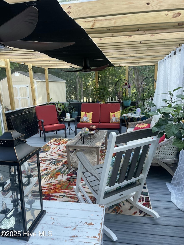 wooden terrace with an outdoor structure, a shed, and an outdoor hangout area