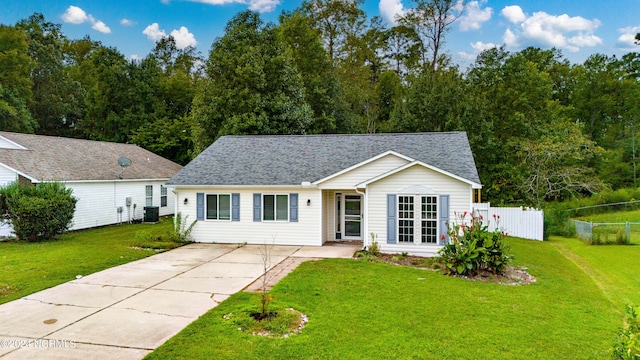 single story home with driveway, a shingled roof, a front lawn, and fence