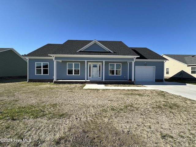 view of front facade featuring a front yard and a garage