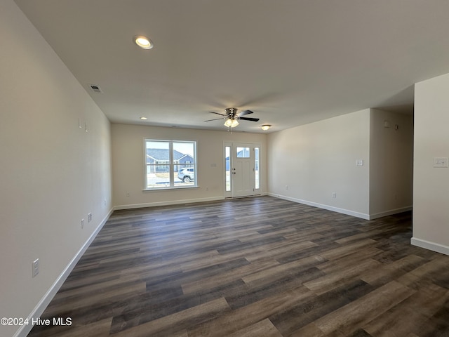 spare room featuring dark hardwood / wood-style flooring and ceiling fan