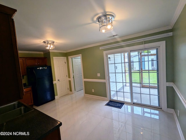 interior space featuring sink, light tile patterned floors, and crown molding