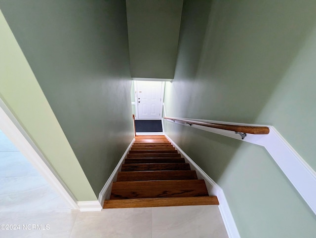 stairs featuring wood-type flooring